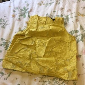 Yellow embroidered floral shirt.